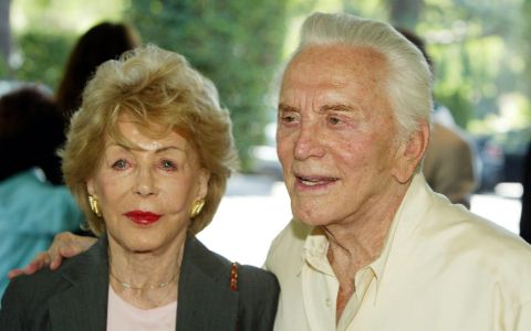 Anne Douglas and Kirk Douglas pose for a picture.